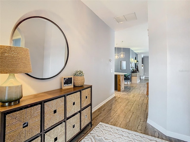 hallway featuring a chandelier and hardwood / wood-style flooring