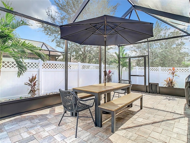 view of patio with glass enclosure