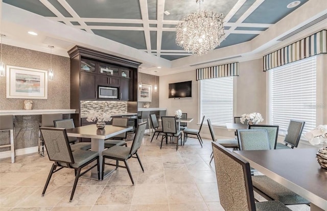 dining space featuring a chandelier and coffered ceiling