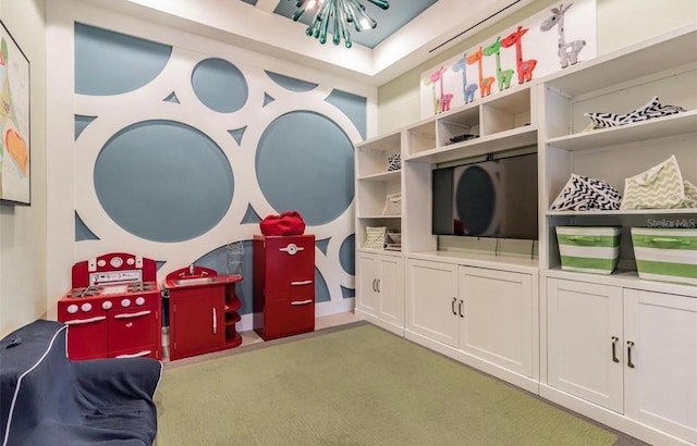 rec room featuring carpet and an inviting chandelier