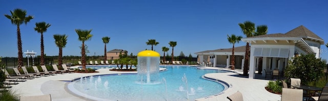 view of pool featuring pool water feature and a patio