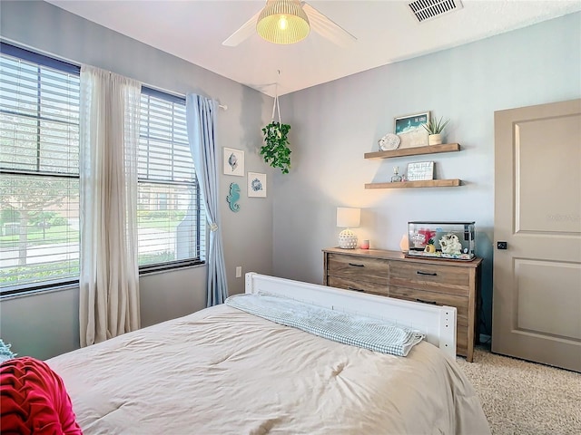 bedroom with ceiling fan and multiple windows