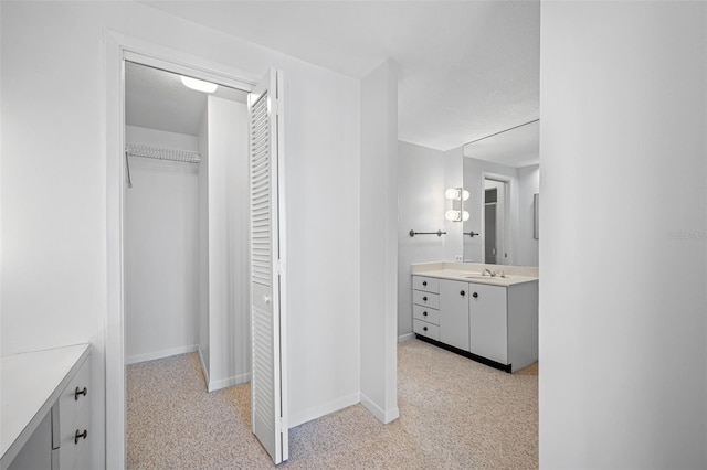full bathroom featuring baseboards, carpet, and vanity