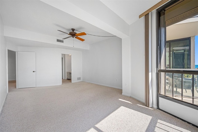 interior space featuring carpet flooring, baseboards, ceiling fan, and visible vents