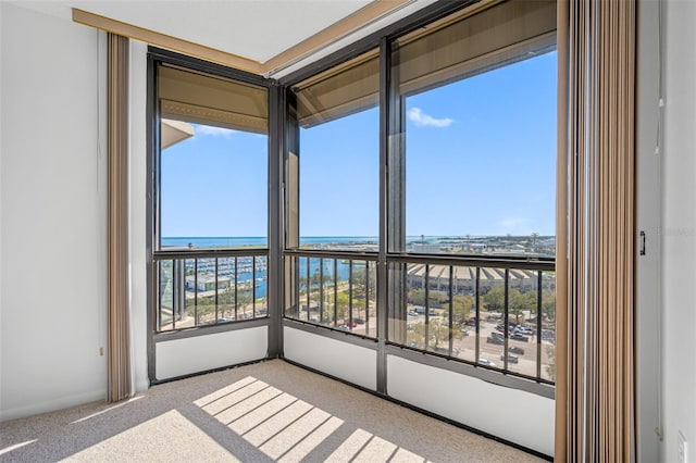 unfurnished sunroom featuring a water view