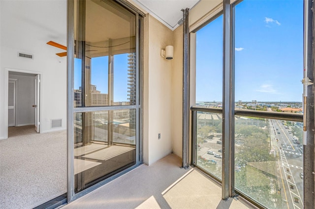 unfurnished sunroom featuring a view of city and visible vents