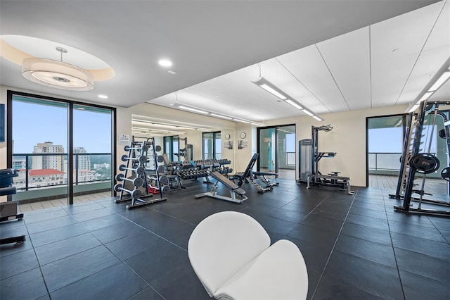 gym featuring a view of city and expansive windows