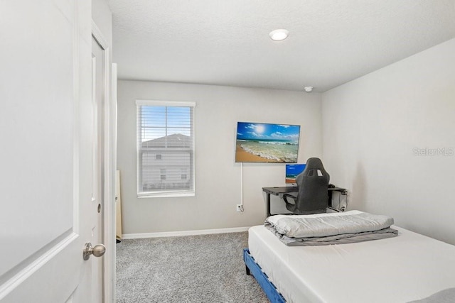 bedroom with a textured ceiling and carpet