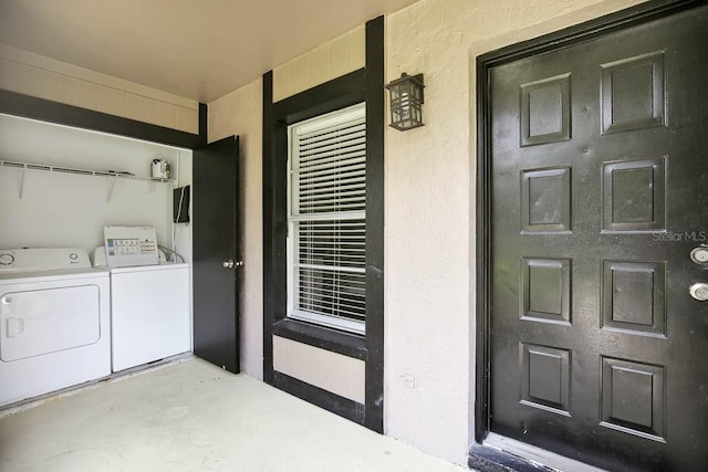 view of exterior entry with separate washer and dryer