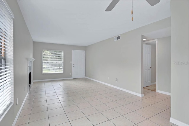 unfurnished living room with ceiling fan and light tile patterned floors