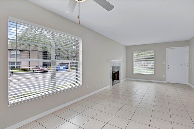 unfurnished living room featuring ceiling fan and light tile patterned flooring