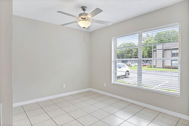 unfurnished room with ceiling fan and light tile patterned flooring