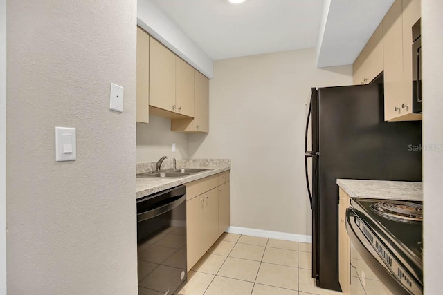 kitchen with black appliances, cream cabinets, sink, and light tile patterned floors