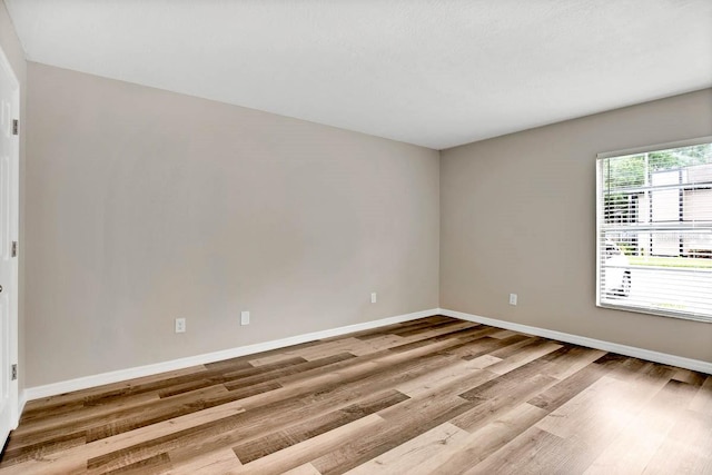 unfurnished room featuring hardwood / wood-style flooring