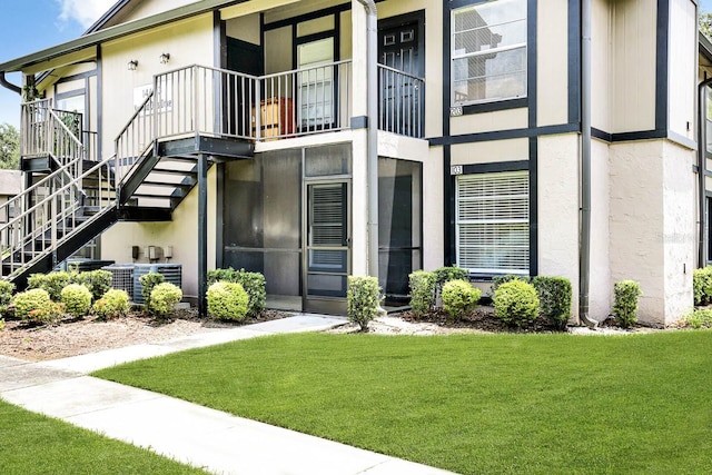 exterior space featuring a balcony and a lawn