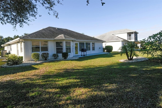 2451 E Del Webb Blvd, Sun City Center, FL 33573 - back of property featuring a yard and stucco siding
