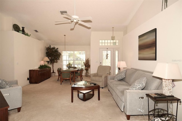 carpeted living room featuring ceiling fan and high vaulted ceiling