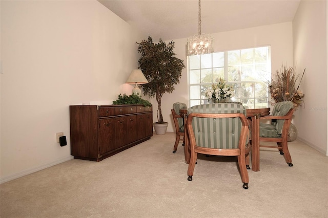 carpeted dining space with lofted ceiling and an inviting chandelier