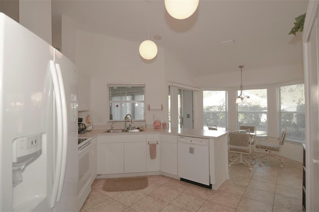 kitchen with white cabinetry, white appliances, kitchen peninsula, pendant lighting, and sink