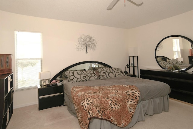 bedroom featuring light carpet and ceiling fan