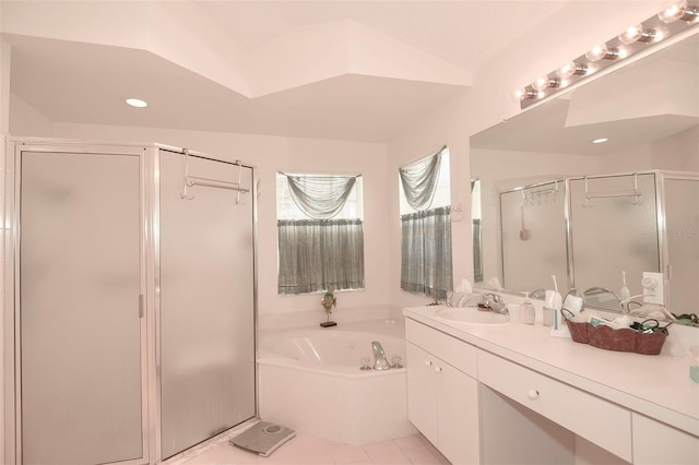 bathroom featuring vaulted ceiling, vanity, plus walk in shower, and tile patterned flooring