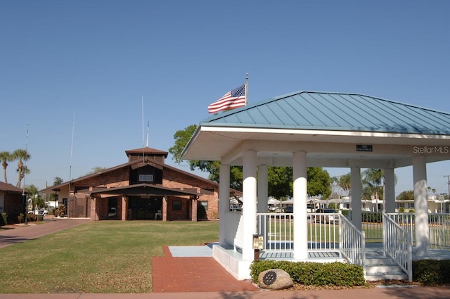 surrounding community with a gazebo and a lawn