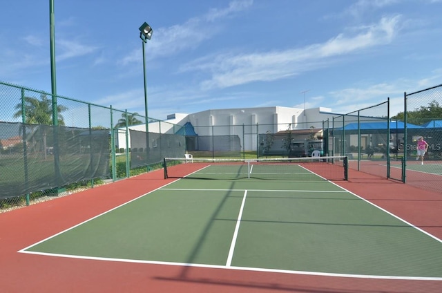 view of sport court with basketball hoop