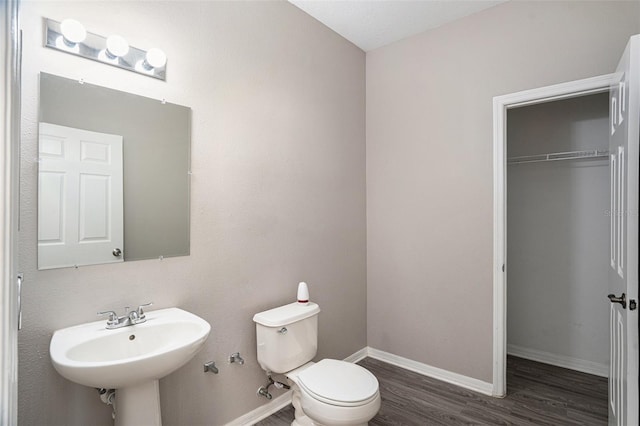 bathroom featuring toilet, hardwood / wood-style flooring, and sink