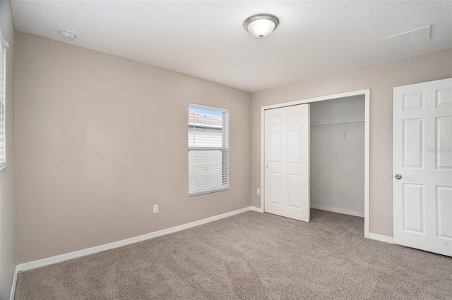 unfurnished bedroom featuring a closet and carpet floors