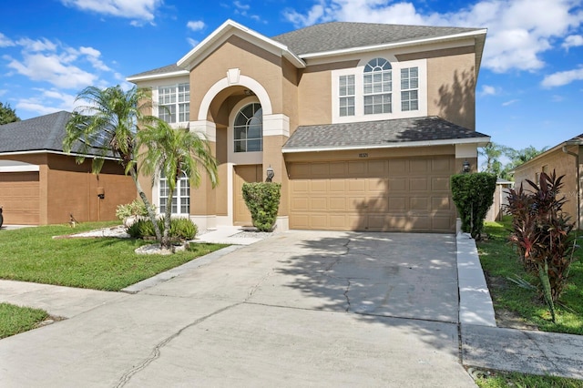 view of front of property with a garage and a front lawn