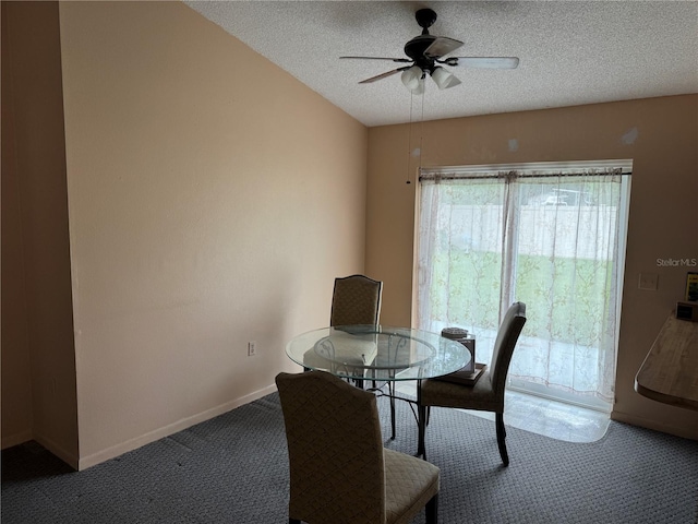 dining space with ceiling fan, carpet floors, and a textured ceiling