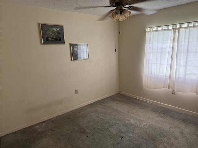 carpeted empty room featuring ceiling fan and a textured ceiling