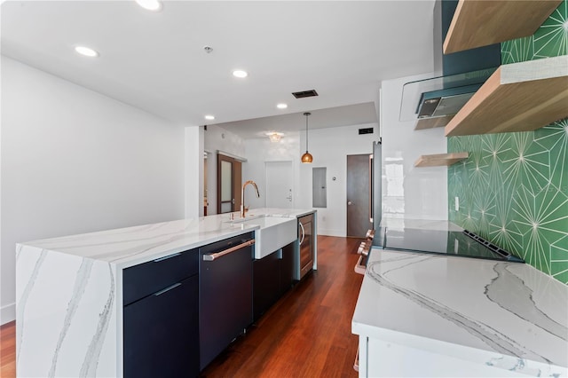 kitchen featuring sink, a center island with sink, dishwasher, stovetop, and dark hardwood / wood-style floors