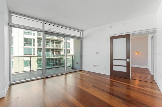 unfurnished room with hardwood / wood-style floors