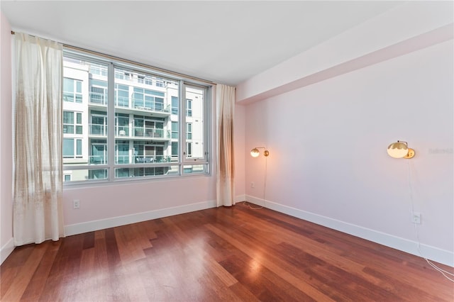 unfurnished room featuring dark hardwood / wood-style flooring