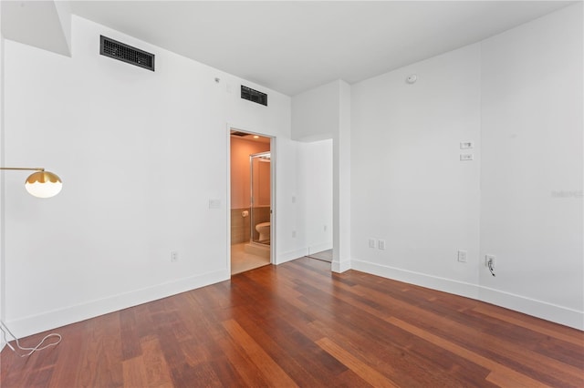 spare room featuring dark wood-type flooring