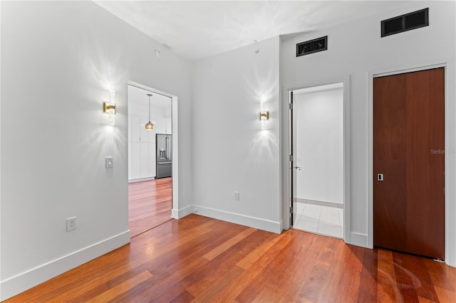 spare room featuring wood-type flooring