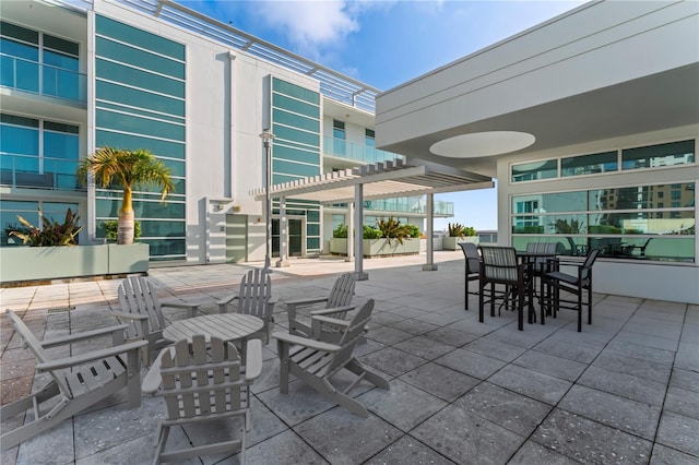 view of patio / terrace with a balcony and a pergola