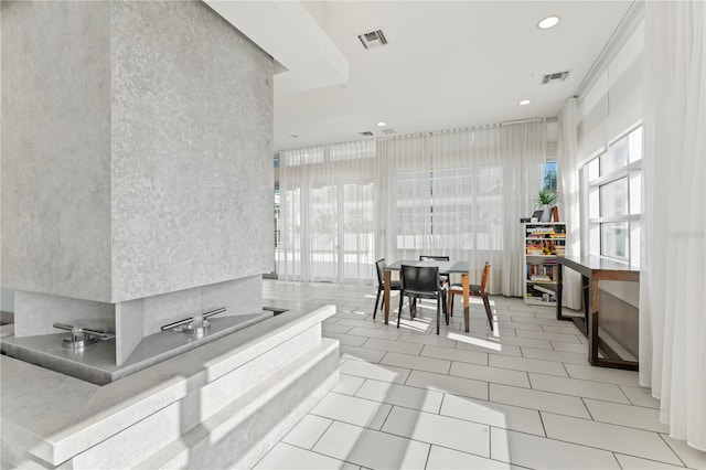 kitchen featuring a towering ceiling and light tile patterned floors