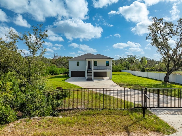 view of front of house featuring a garage and a front lawn