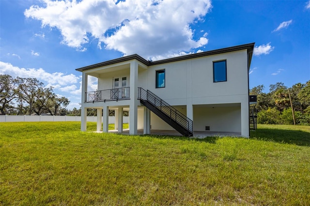 rear view of house featuring a lawn