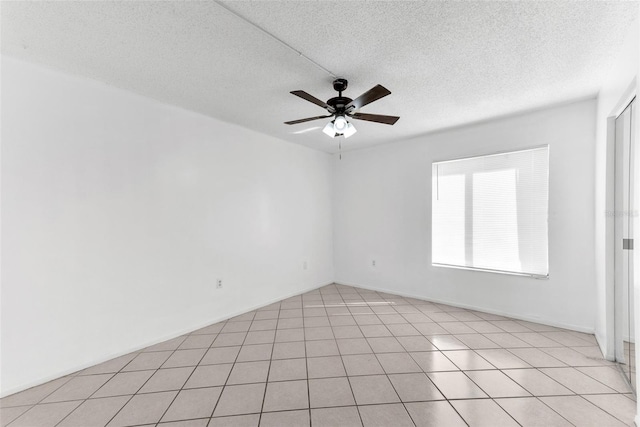 unfurnished room featuring ceiling fan, a textured ceiling, and light tile patterned floors