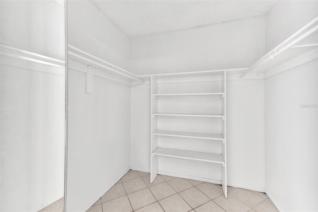 spacious closet featuring light tile patterned floors