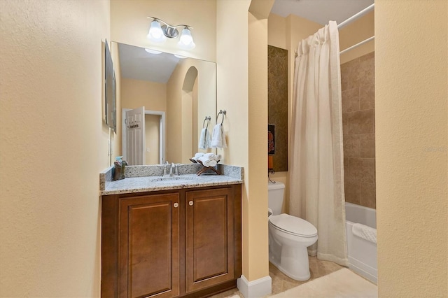 full bathroom with shower / tub combo with curtain, tile patterned flooring, vanity, and toilet