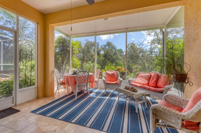 sunroom / solarium featuring ceiling fan and a wealth of natural light