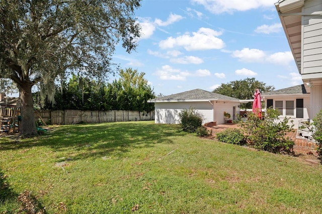 view of yard with a playground and a garage