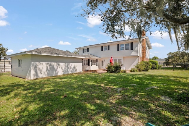 rear view of house with a lawn