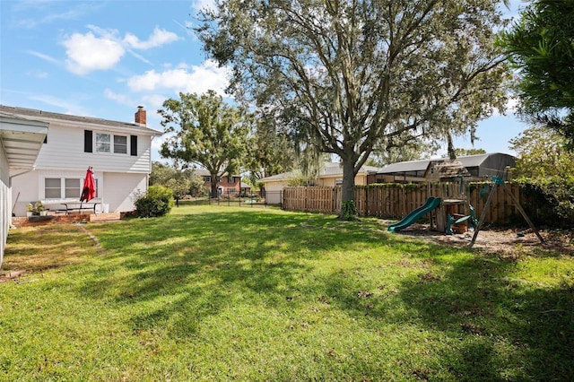 view of yard with a patio area and a playground