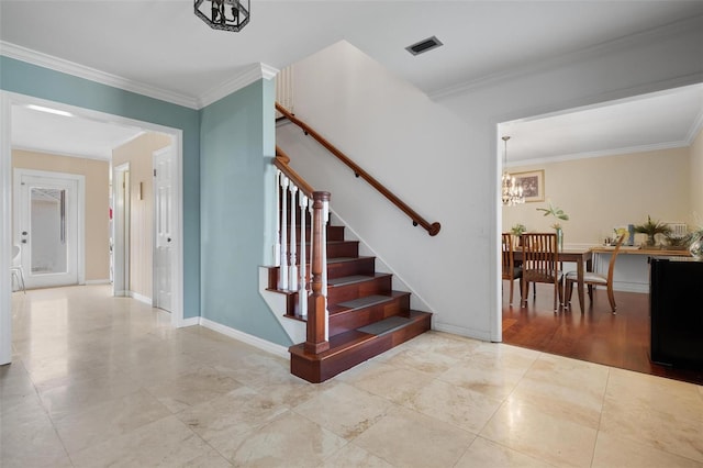 stairs with crown molding and an inviting chandelier