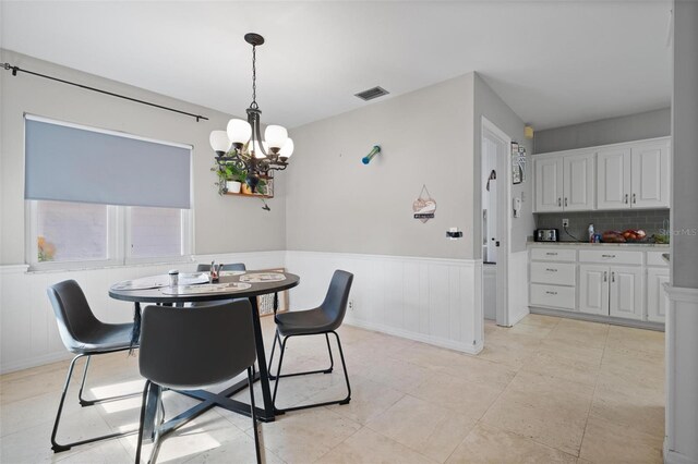 dining room featuring a chandelier and light tile patterned flooring